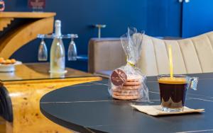 a table with a cup of coffee and cookies on it at La Flûte enchantée in Troyes