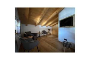 a living room with a couch and a tv at Holiday apartment Filzstein Chalet in Kirchdorf