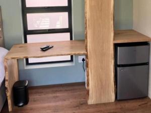 a wooden desk in a room with a window at 38onOak in Ceres