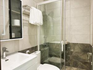 a bathroom with a shower and a toilet and a sink at Chez Mimosa Petite - Free Laundry in Ho Chi Minh City