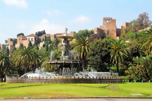 a fountain in a park in front of a castle at Soho Urban Flat in Málaga