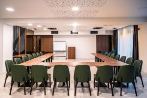 a conference room with a long table and chairs at Hotel Adriale in Kreševo