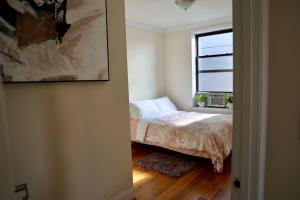 a bedroom with a bed and a window at Apartment in New York By Central Park in New York