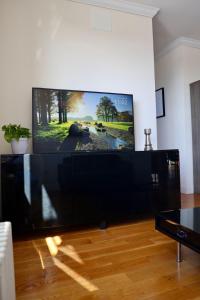 a large flat screen tv sitting in a living room at Apartment in New York By Central Park in New York