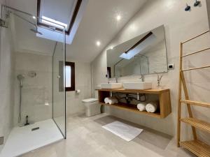 a bathroom with a shower and a sink and a mirror at Villa Gratal in Igriés