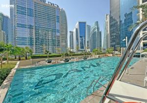 a swimming pool in a city with tall buildings at bnbmehomes - Business Bay Beauty w/ City Views - 1816 in Dubai