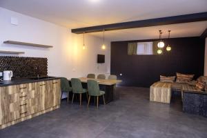 - une cuisine et une salle à manger avec une table et des chaises dans l'établissement Villa Ipanema, à Telavi