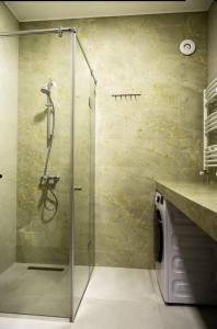 y baño con ducha y puerta de cristal. en Villa Ipanema, en Telavi