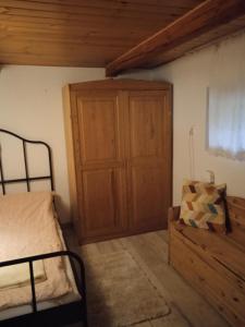 a bedroom with a bed and a wooden cabinet at Cottage in the picturesque Beskid Maly Mountains in Porąbka