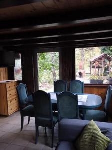 a dining room with a table and chairs at Cottage in the picturesque Beskid Maly Mountains in Porąbka