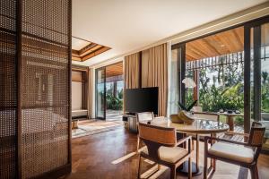 a living room with a table and chairs at The Meru Sanur in Sanur