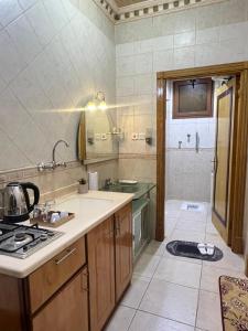 a kitchen with a sink and a stove at دار اليقين in Al Madinah +35 photos