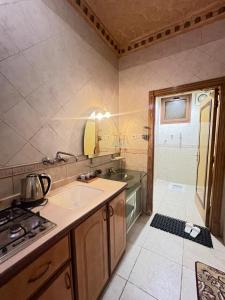 a kitchen with a sink and a stove in it at دار اليقين in Al Madinah