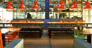 a restaurant with tables and chairs and red lights at Trupial Hotel & Casino in Willemstad