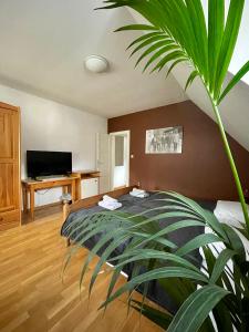 a bedroom with a bed and a potted plant at Gostišče Barbara in Idrija