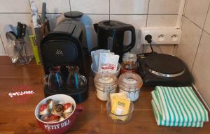 a counter top with a coffee maker and some food at CHEZ KIKI & MIMI 