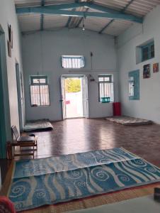 a large room with a large rug on the floor at Shanthi House in Mysore