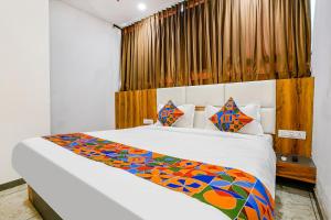 a bedroom with two beds in a room at FabHotel Prime Dumas in Surat