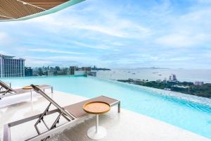 a swimming pool on the roof of a building at Akara Hotel Pattaya in Pattaya North