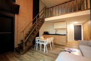 a kitchen and dining room with a staircase in a house at Bizon Village in Zalesie Górne