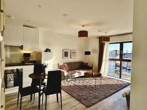 a living room with a couch and a table at Newly built apt in central Derby with on street parking in Derby