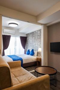 a hotel room with two beds and a couch at FDS Plaisir in Osaka +37 photos