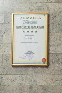 a sign for a certificate of glassace on a wall at Pensiunea Marylou in Alba Iulia