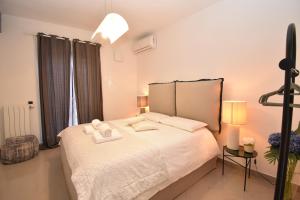 a bedroom with a bed with two towels on it at Diasof Apartments in Rome