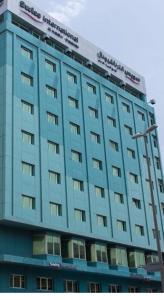 a blue building with a sign on top of it at Swiss International Al Hamra Hotel in Dammam