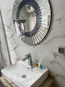 a bathroom with a sink and a mirror at Address hotel and towers Abuja in Abuja