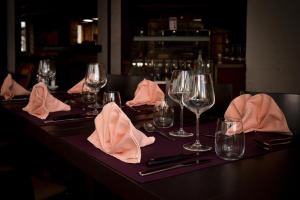 - une table avec des verres à vin et des serviettes dans l'établissement Hotel La Croix Blanche - Bassecourt, 