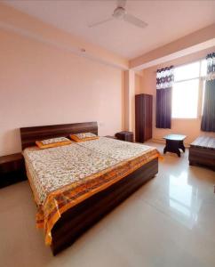 a bedroom with a large bed and a couch at Hotel Hill Valley, Ooty in Ooty