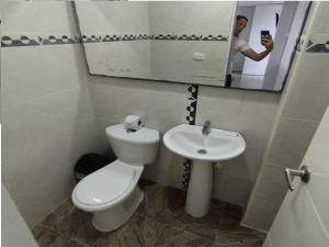 a man taking a picture of a bathroom with a toilet and sink at Bm-7 room near the sea with air conditioning and WIFI in Cartagena de Indias +3 photos