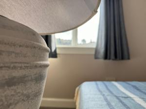 a bedroom with a bed and a window at Bunessan Inn in Bunessan