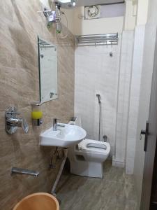 a bathroom with a sink and a toilet at Hotel Shree Narayan Palace in Jaipur