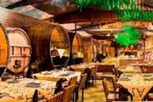 a restaurant with tables and chairs in a room at 4 Rooms Playa Surf Cine- Parking y Terraza in Donostia-San Sebastián