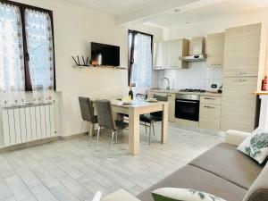 a kitchen and living room with a table and chairs at Piccola Luna in Menaggio