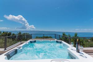 a hot tub on the balcony of a house at Betelgeuse in Jesenice