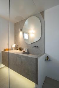 a bathroom with a sink and a mirror at Villa Alabaster by Mykonos Rocks in Klouvas