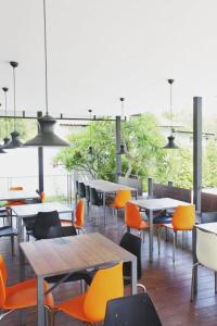 comedor con mesas y sillas y vistas en Lee Nova Hotel en Bangna
