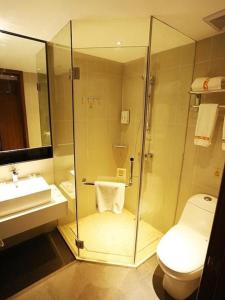 a bathroom with a shower and a toilet and a sink at JTOUR Inn Wuxi Railway Station Shangmadun Metro Station in Wuxi