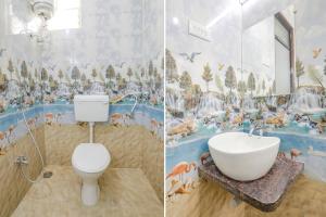 a bathroom with a sink and a toilet and a mural at FabHotel Blue Ocean MNJ Resort in Nashik
