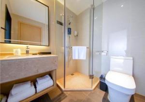 a bathroom with a shower and a toilet and a sink at City Comfort Inn Haikou Zhongjie Road Walking Street in Haikou