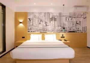 a bedroom with a large bed with a drawing on the wall at City Comfort Inn Haikou Zhongjie Road Walking Street in Haikou