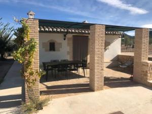 a patio with a table and a dining room at Casita rural entre olivos in Biar