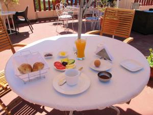 a white table with breakfast food on it at Park Hostel in Arequipa