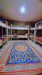 a large room with a rug on the floor at Neena S Hostel in Ban Nua