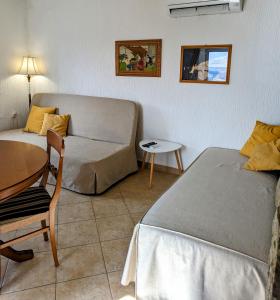 Sala de estar con 2 camas y mesa en Apartment Fragola, en Ankaran