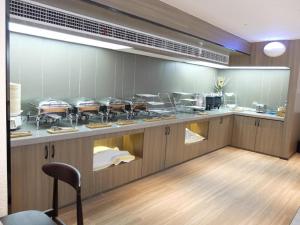 a restaurant kitchen with a counter with many dishes at Hanting Hotel Shangrao Wanda in Shangrao