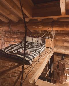 una cama colgada de un techo de madera en una habitación en Chalet Anzac Chalet 5 Etoiles en Rondins Tout Neuf Unique dans les Aravis, en Les Villards-sur-Thônes